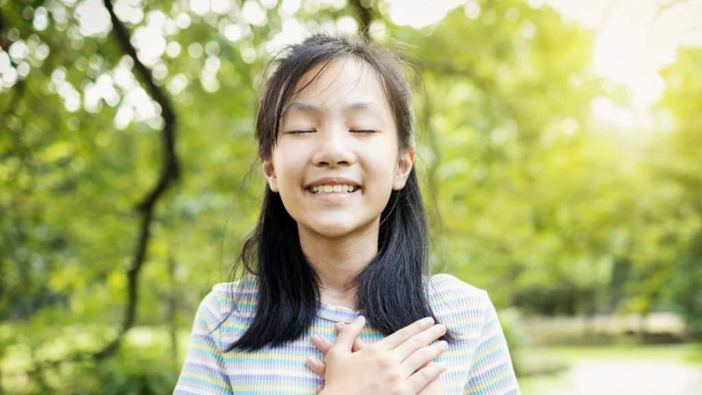 Immigrant smiling confidently in Canada overcoming imposter syndrome